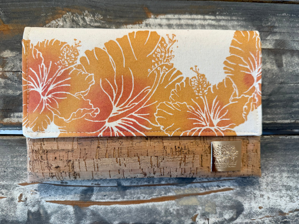 Floral-patterned clutch bag on a textured wooden surface