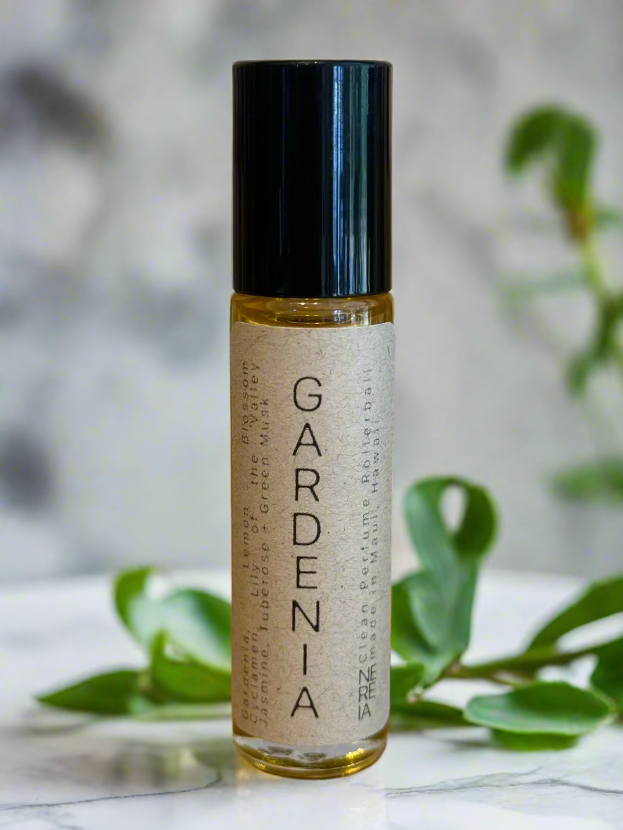 Roll-on bottle labeled 'Gardenia' on a wooden surface with a neutral background