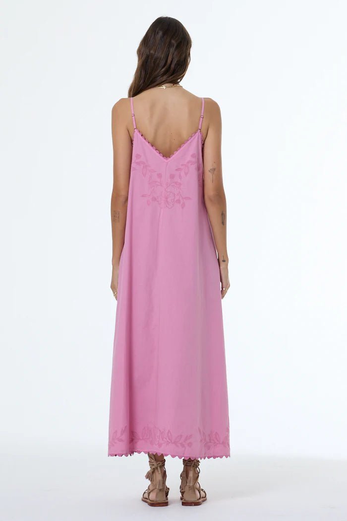 Woman wearing a pink lace dress on a white background