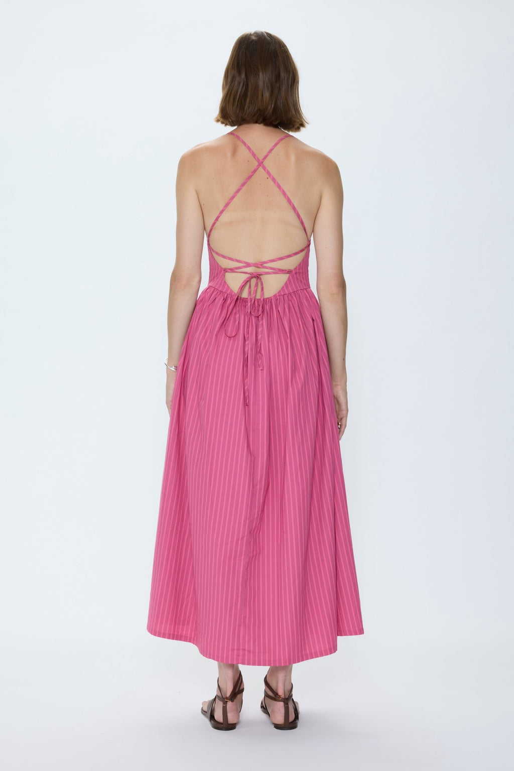 Woman wearing a pink dress on a white background